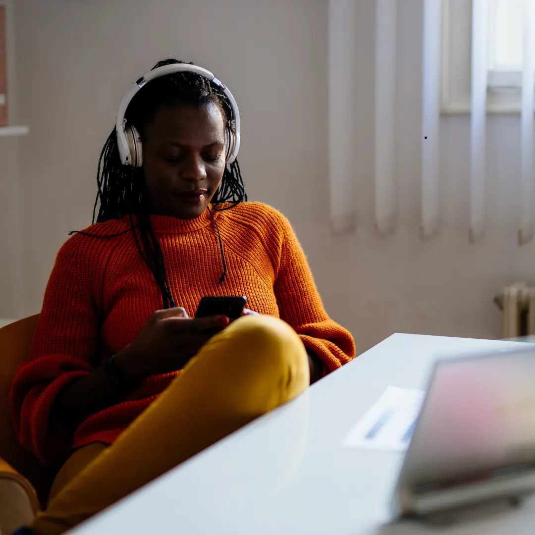 woman-using-mobile-wearing-headphone